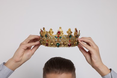 Photo of Man wearing luxury crown on white background, closeup