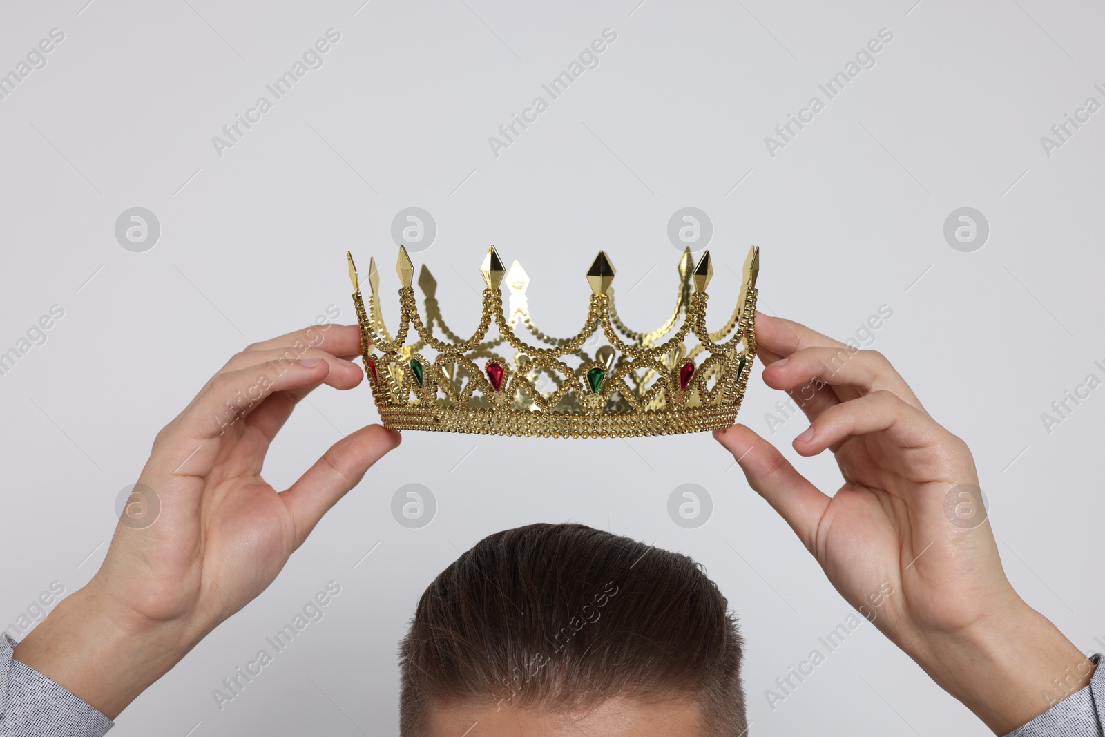 Photo of Man wearing luxury crown on white background, closeup