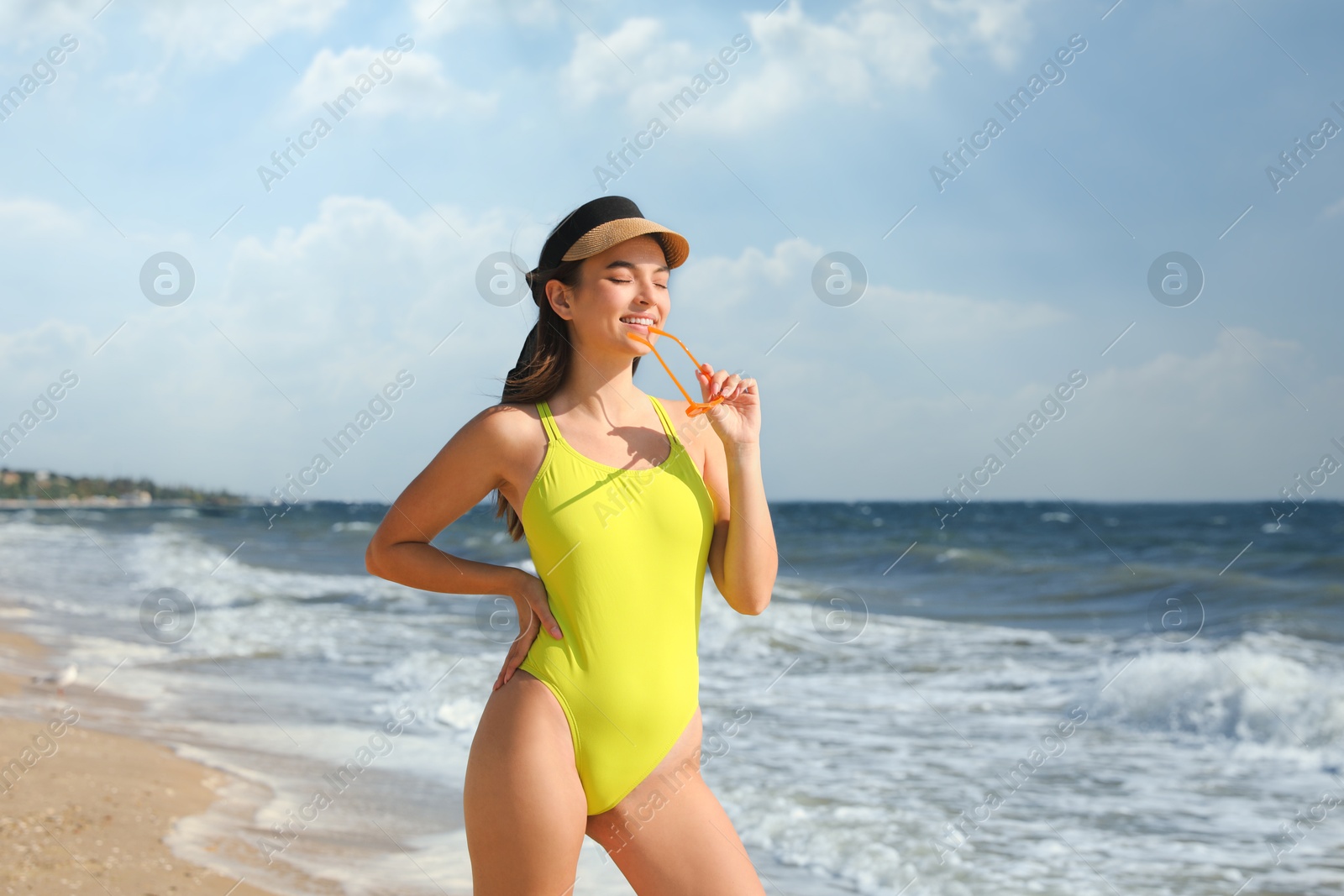 Photo of Beautiful young woman with attractive body on beach