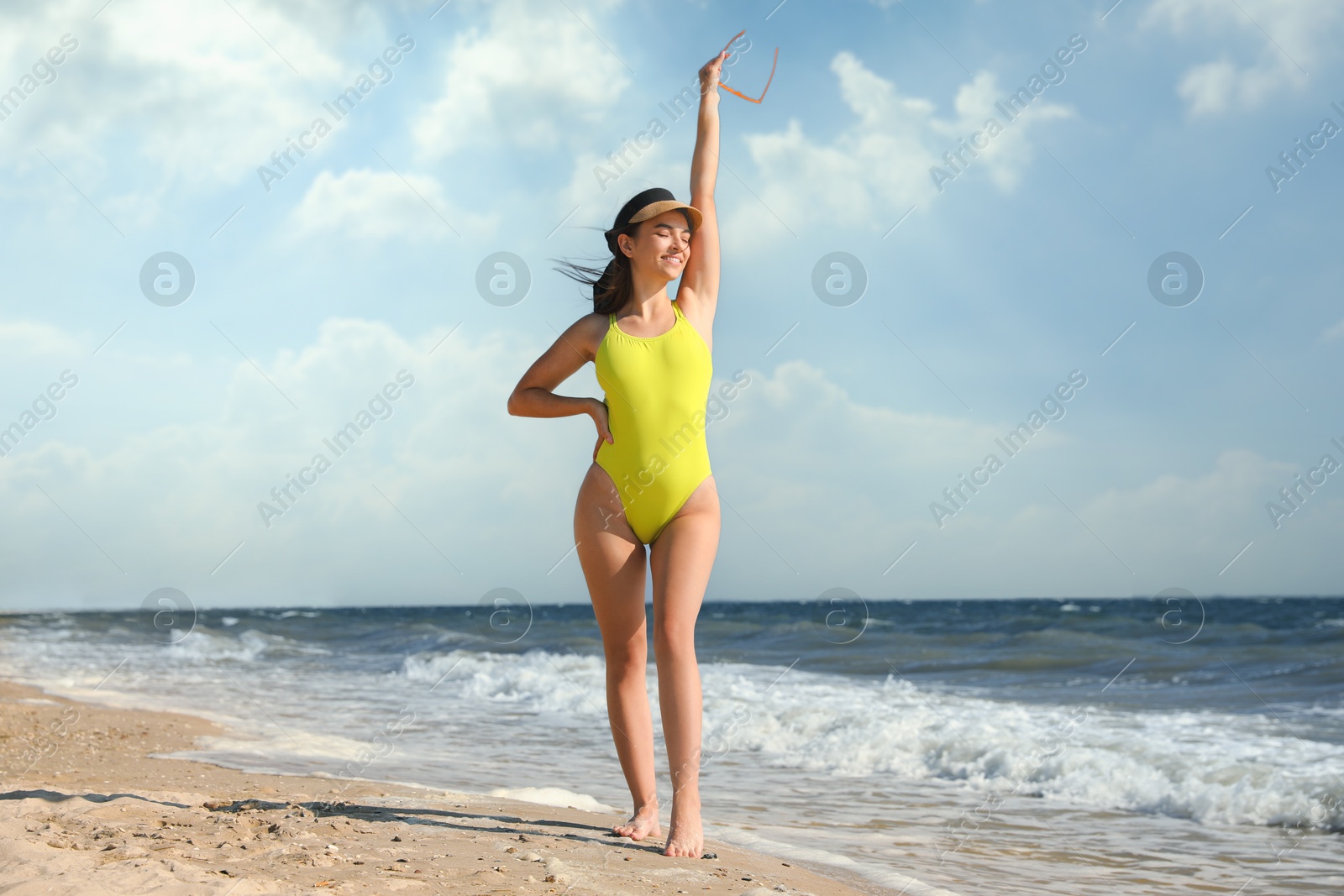 Photo of Beautiful young woman with attractive body on beach