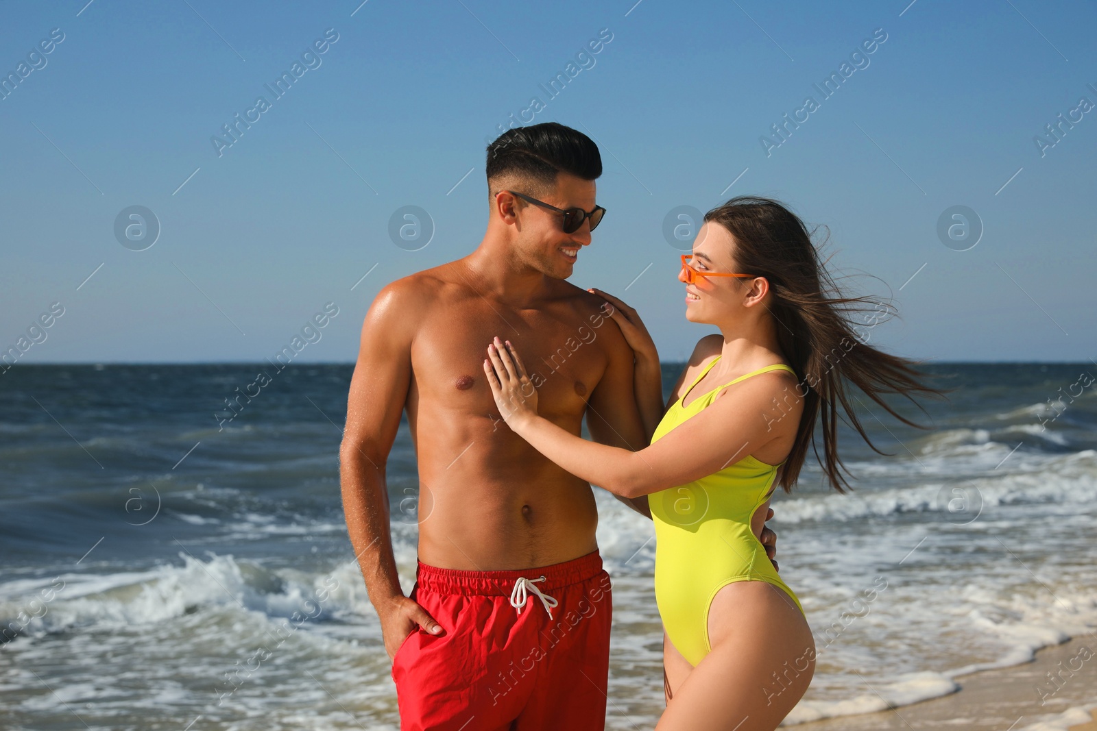 Photo of Lovely couple spending time together on beach