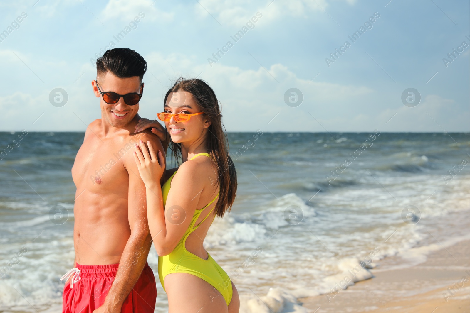 Photo of Lovely couple spending time together on beach