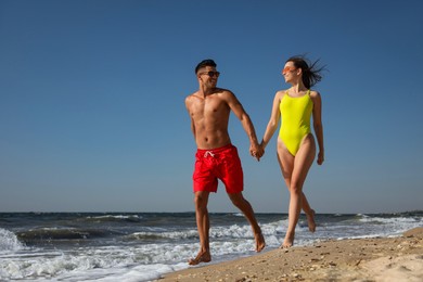 Photo of Lovely couple spending time together on beach