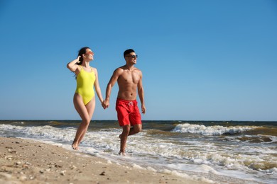 Photo of Lovely couple spending time together on beach