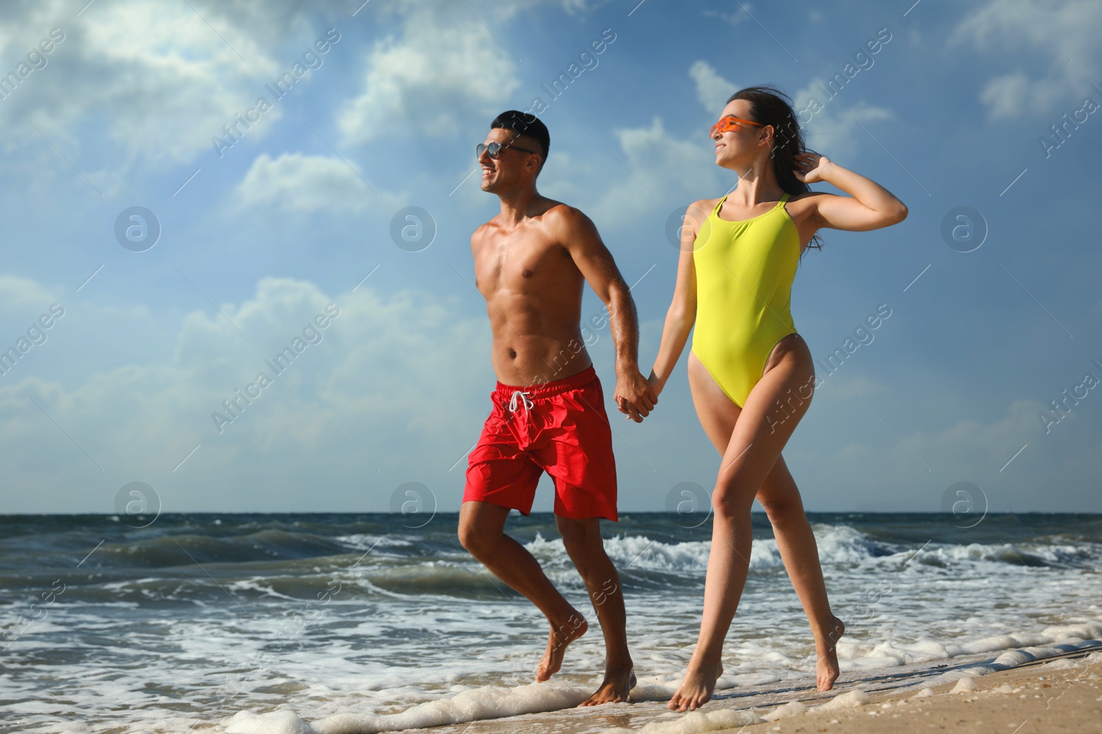 Photo of Lovely couple spending time together on beach