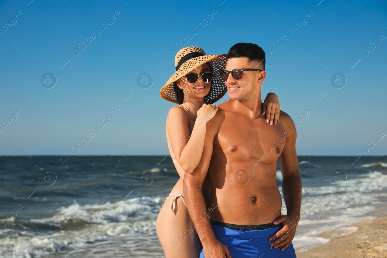 Photo of Lovely couple spending time together on beach