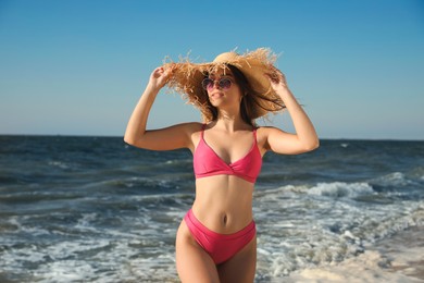 Photo of Beautiful young woman with attractive body on beach