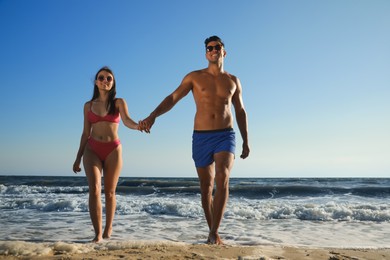 Photo of Lovely couple spending time together on beach