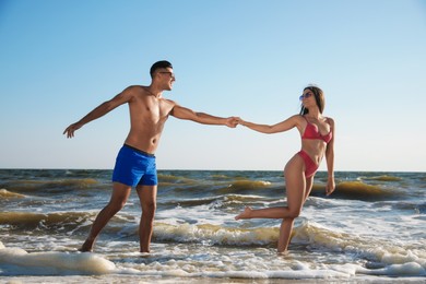 Photo of Lovely couple spending time together on beach