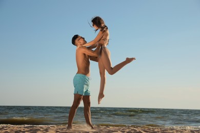 Photo of Lovely couple spending time together on beach