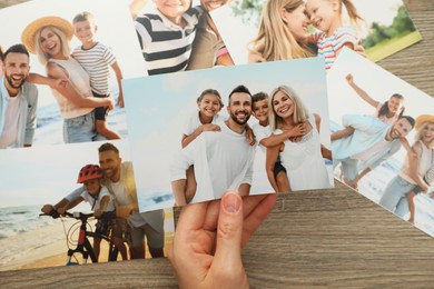 Photo of Woman with different photos at wooden table, top view