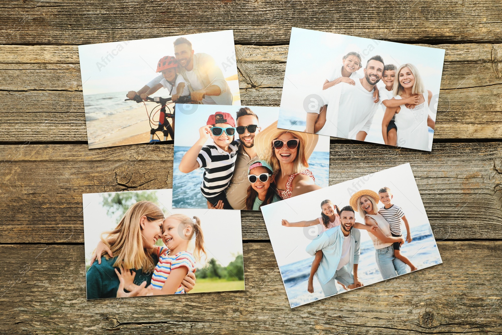 Photo of Different family photos on wooden table, flat lay