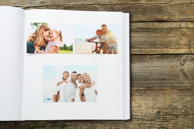 Photo of Different photos in open photo album on wooden table, top view. Space for text