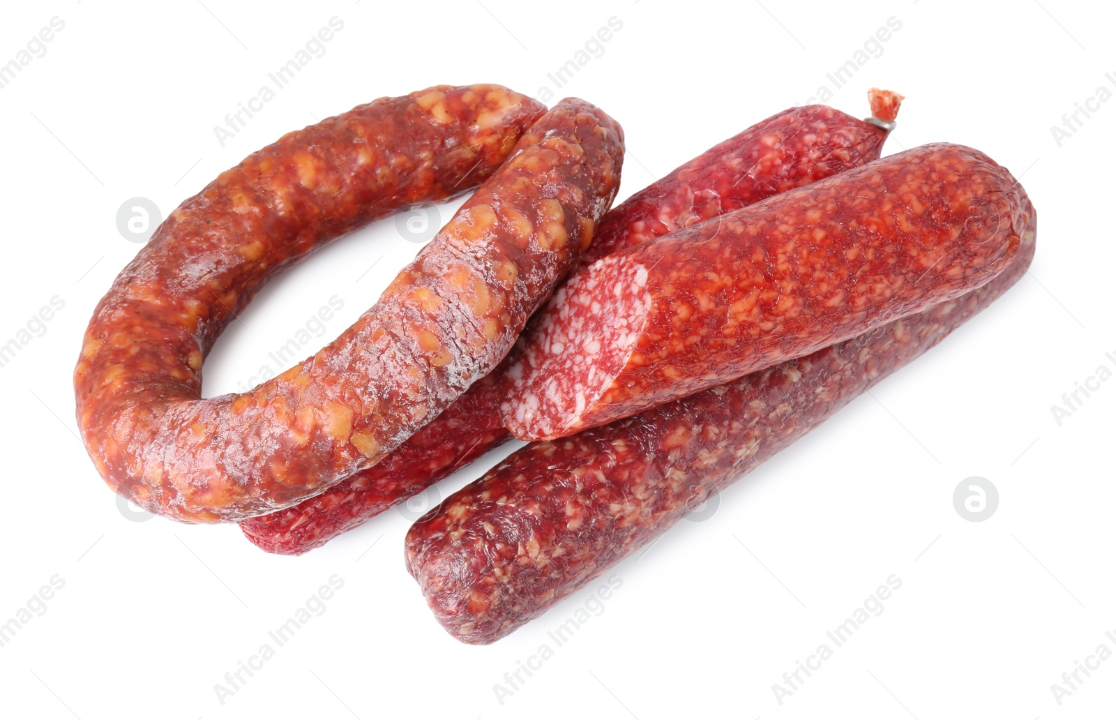 Photo of Many different smoked sausages isolated on white, top view