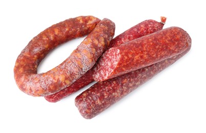 Photo of Many different smoked sausages isolated on white, top view