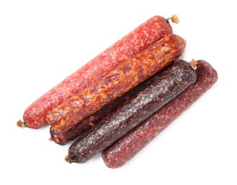 Photo of Many different dry cured sausages isolated on white, top view