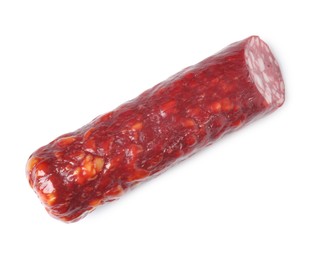 Photo of Piece of delicious dry cured sausage isolated on white, top view