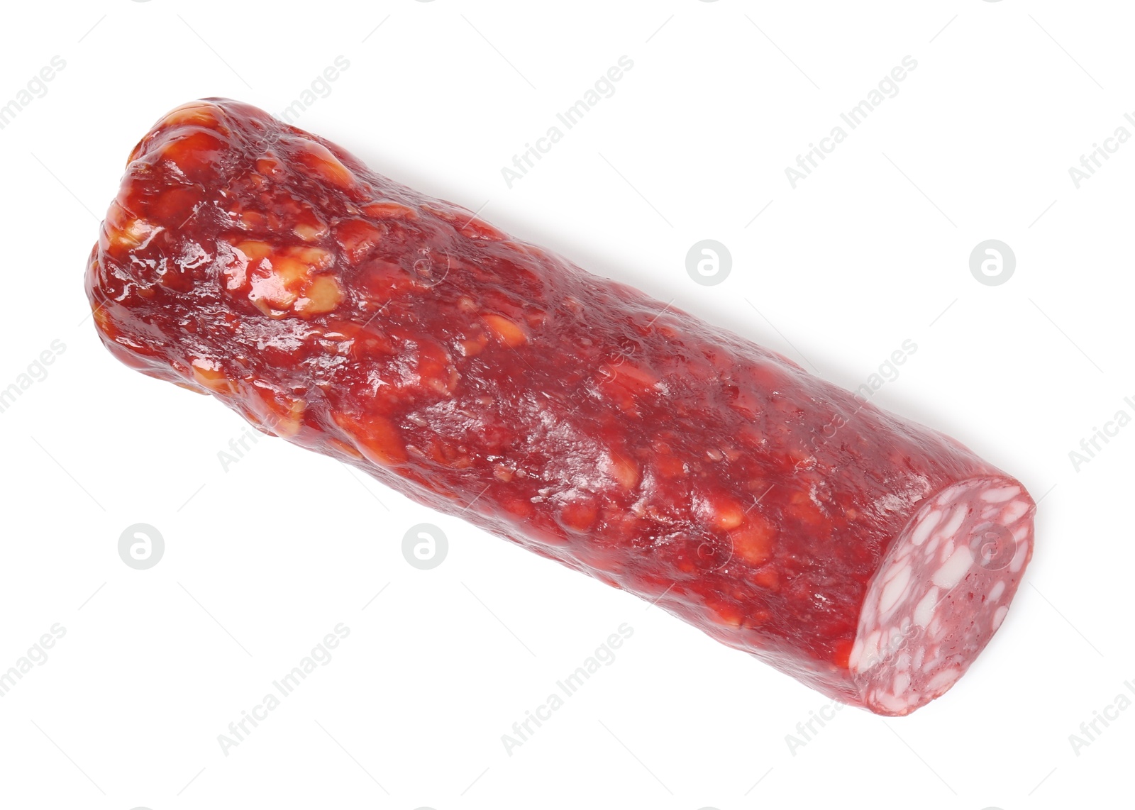 Photo of Piece of delicious dry cured sausage isolated on white, top view