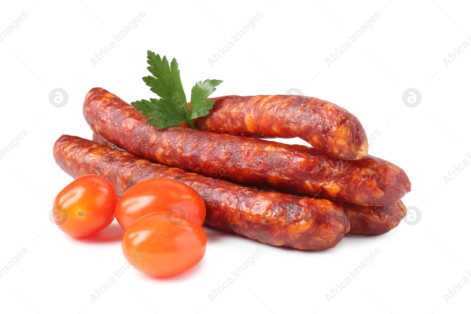 Photo of Many thin dry cured sausages with parsley and tomatoes isolated on white