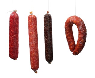 Photo of Many different smoked sausages isolated on white