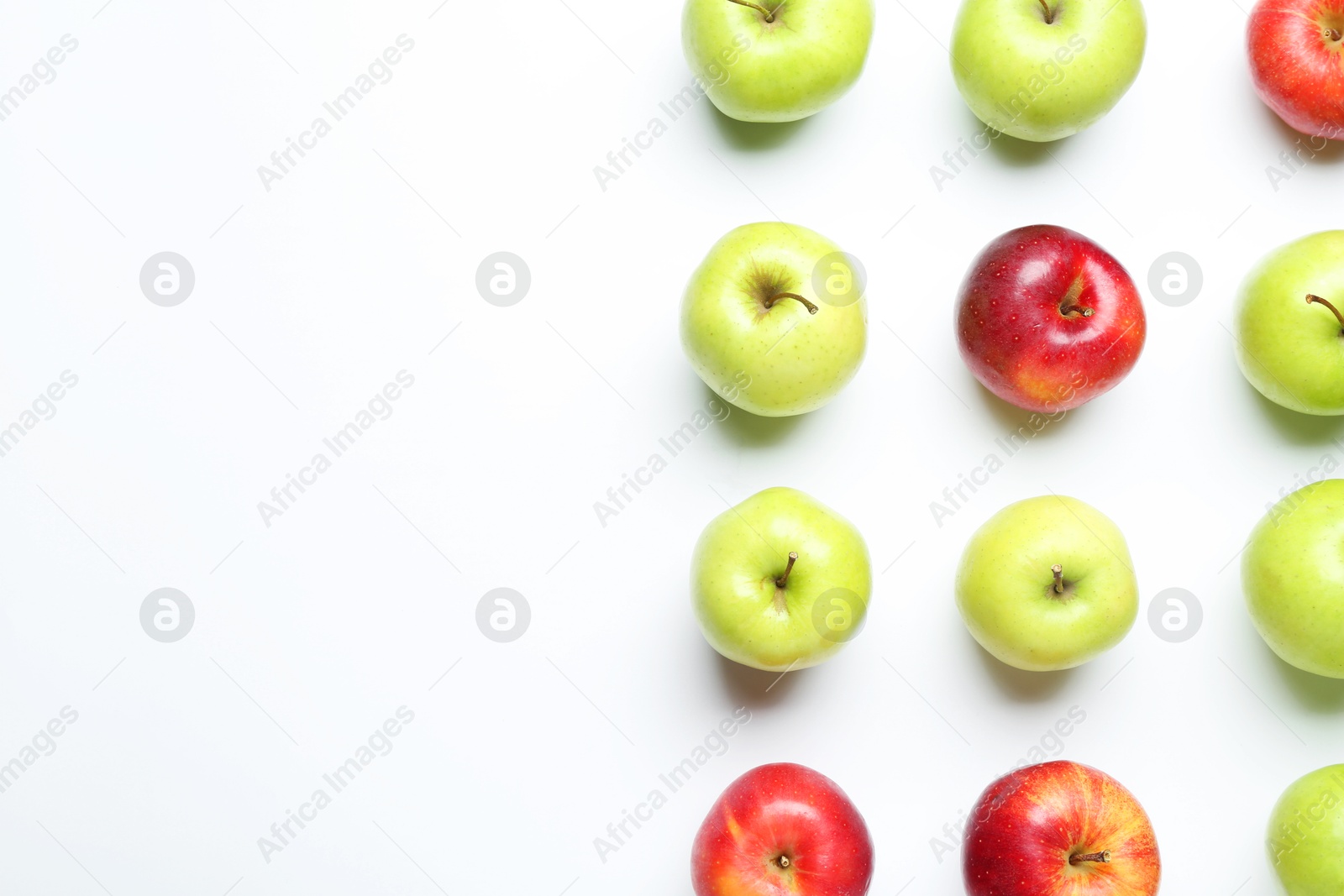 Photo of Red and green apples on white background, flat lay. Space for text