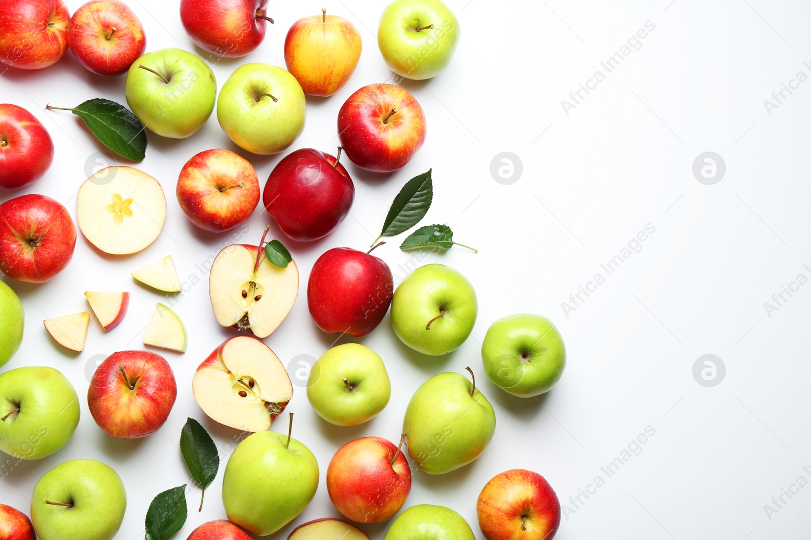 Photo of Flat lay composition with whole and cut apples on white background. Space for text