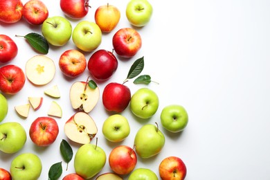 Flat lay composition with whole and cut apples on white background. Space for text