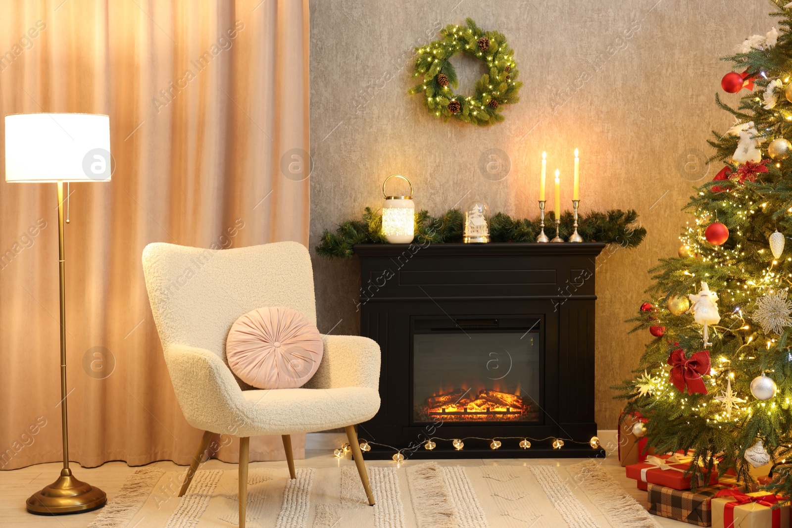 Photo of Fireplace, armchair, Christmas tree and festive decor in cozy room