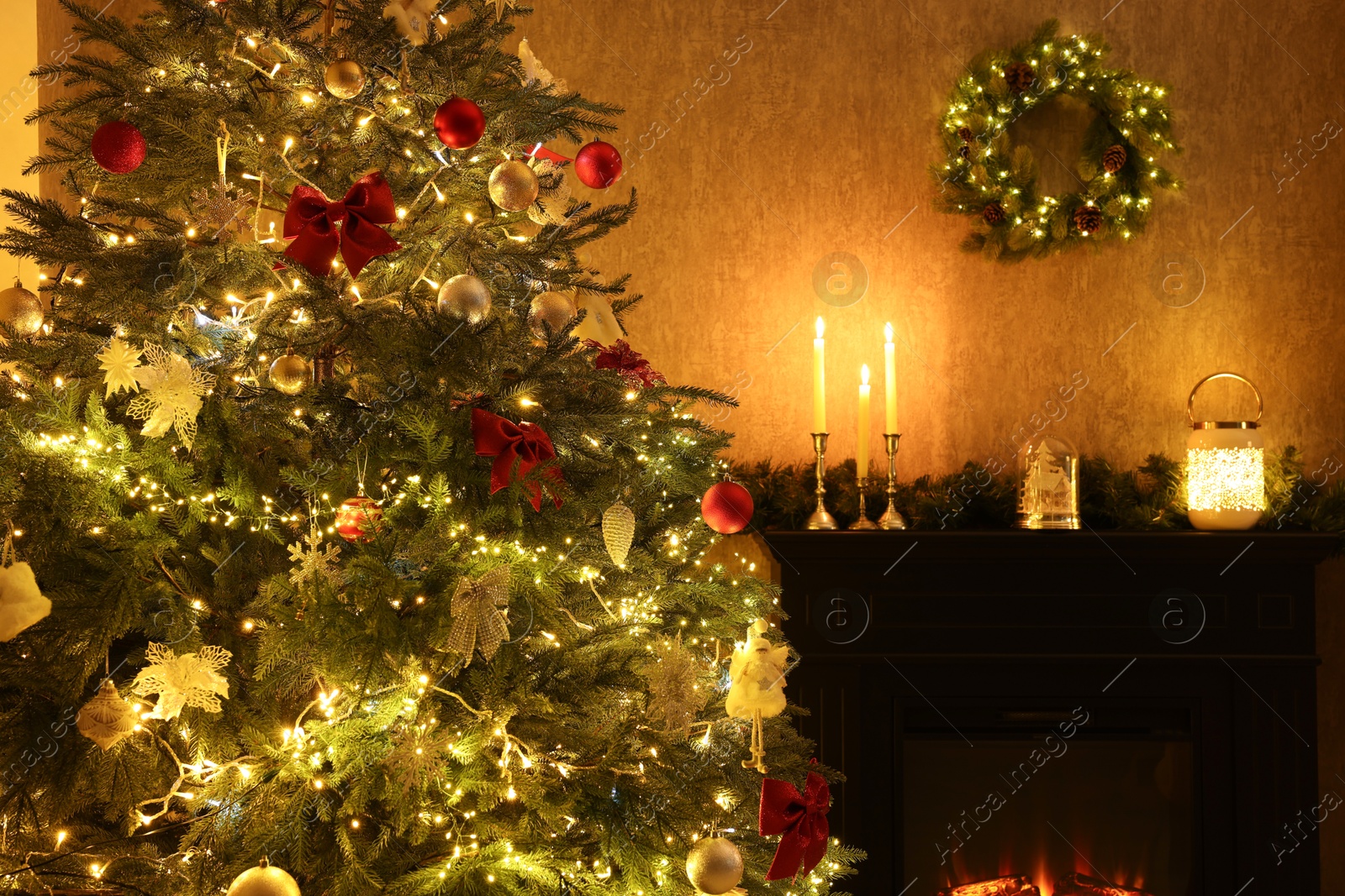 Photo of Beautifully decorated Christmas tree, fireplace and festive decor in room