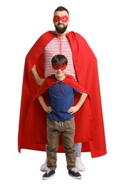 Photo of Father and his son wearing superhero costumes on white background