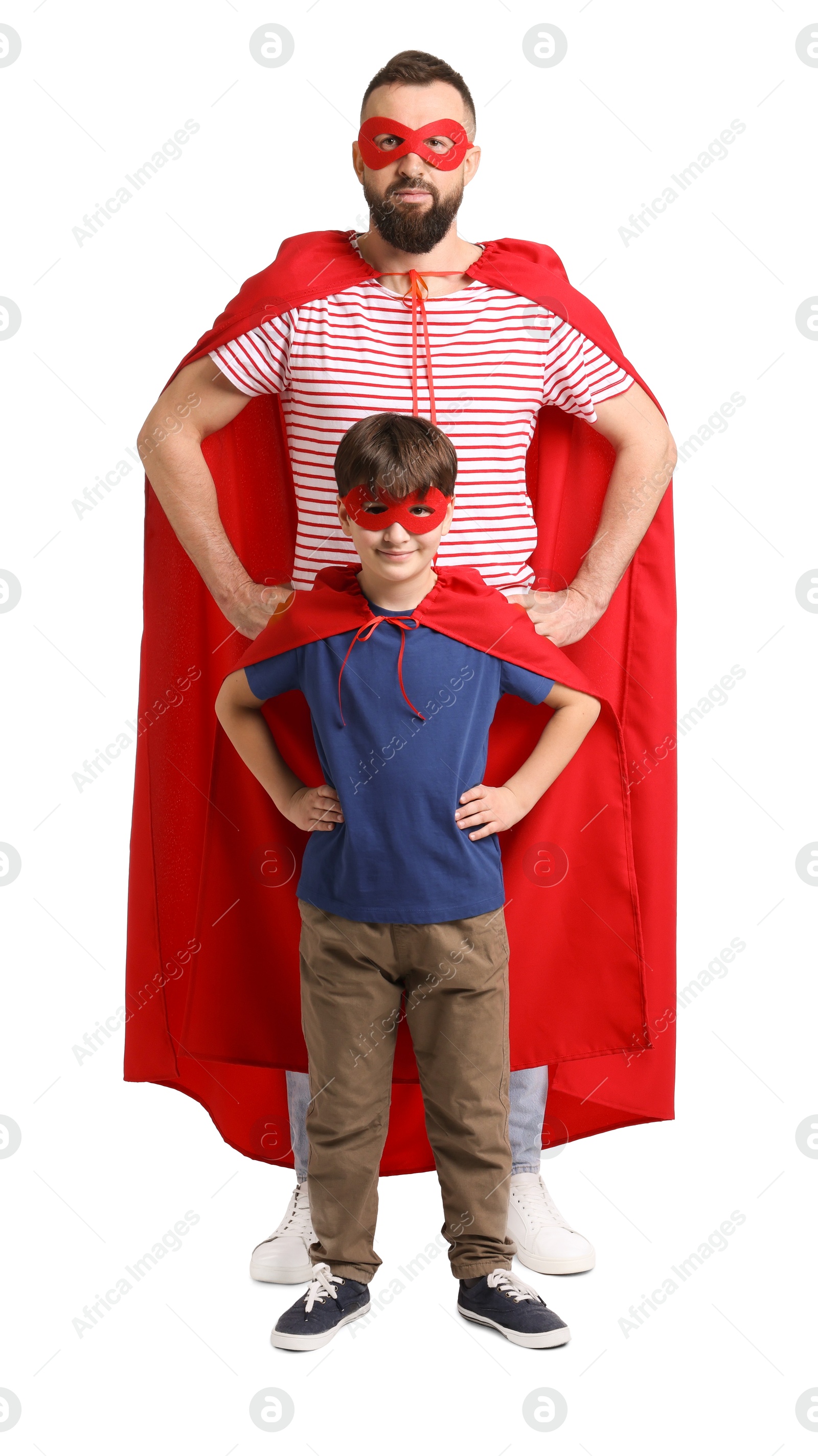 Photo of Father and his son wearing superhero costumes on white background