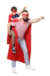 Photo of Father and his son wearing superhero costumes on white background