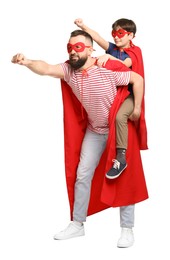 Photo of Father and his son wearing superhero costumes on white background