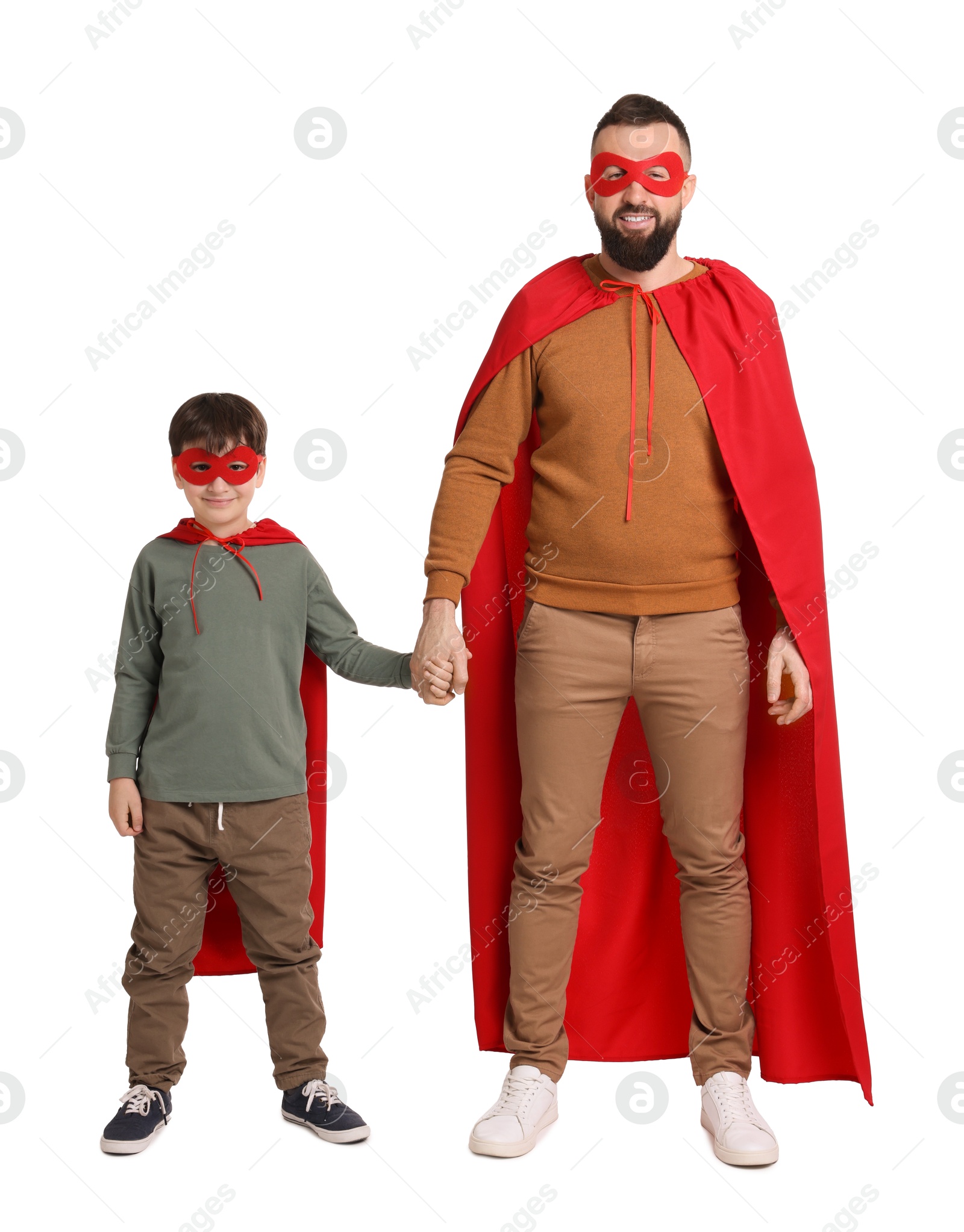 Photo of Father and his son wearing superhero costumes on white background