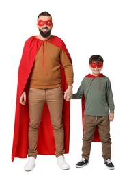 Photo of Father and his son wearing superhero costumes on white background