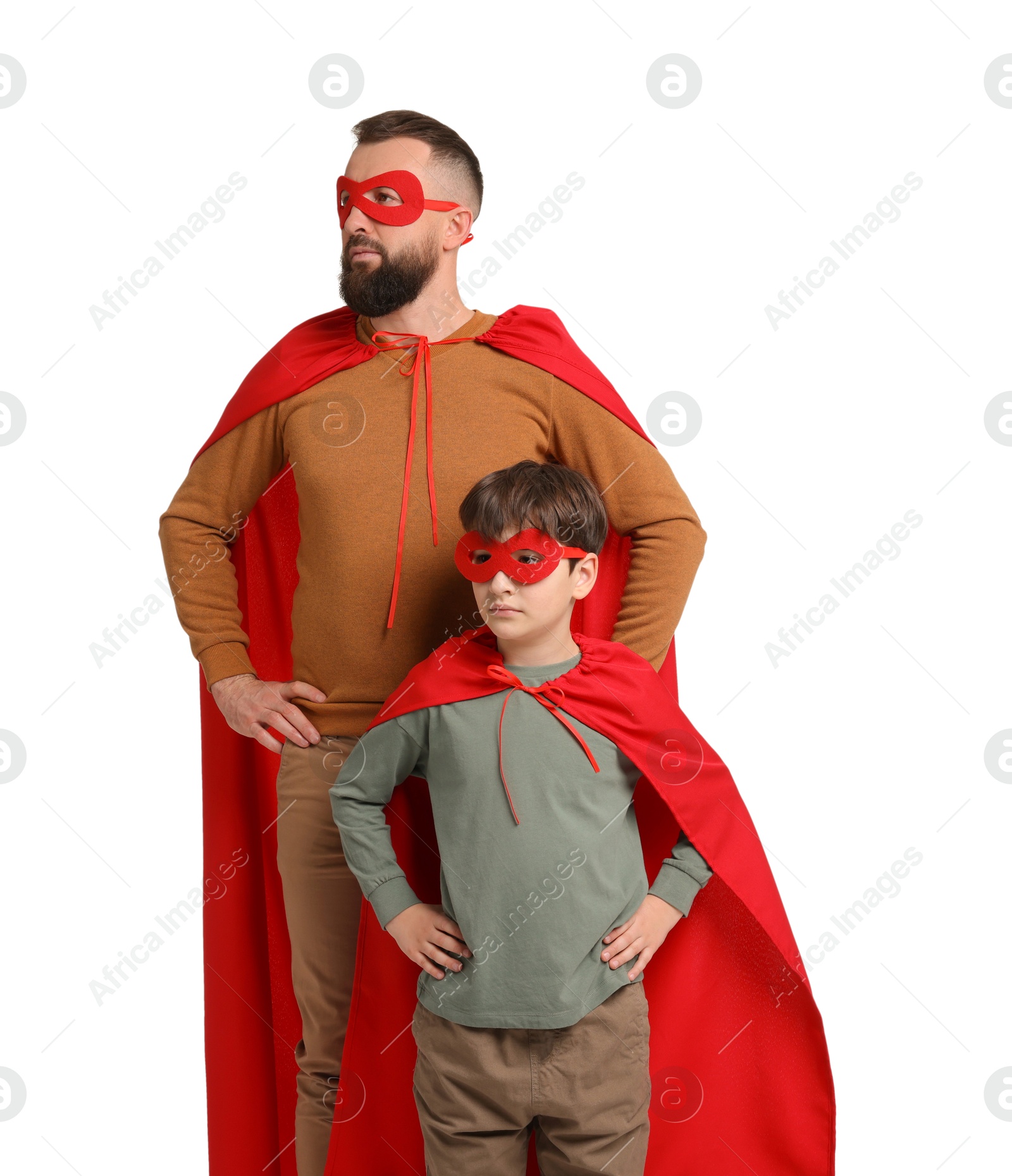 Photo of Father and his son wearing superhero costumes on white background