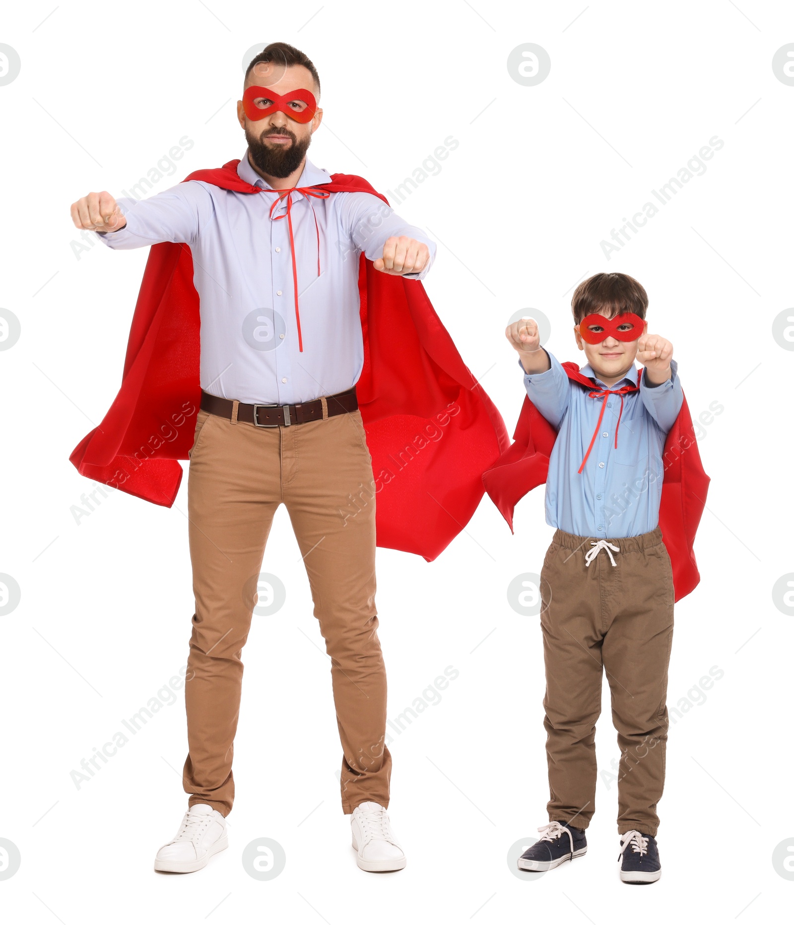 Photo of Father and his son wearing superhero costumes on white background