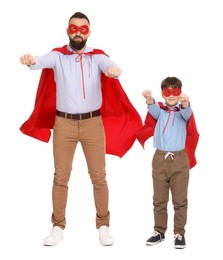 Photo of Father and his son wearing superhero costumes on white background