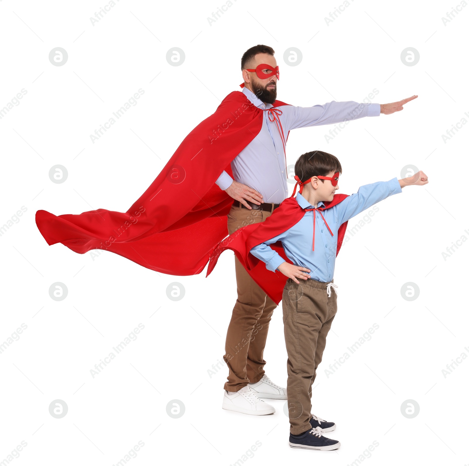 Photo of Father and his son wearing superhero costumes on white background