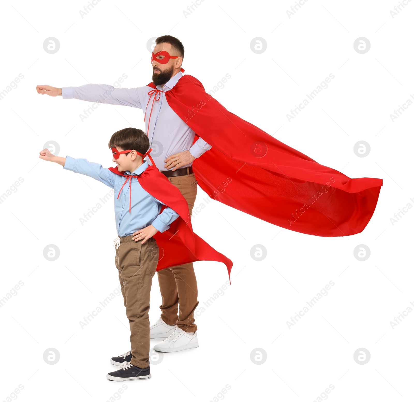 Photo of Father and his son wearing superhero costumes on white background