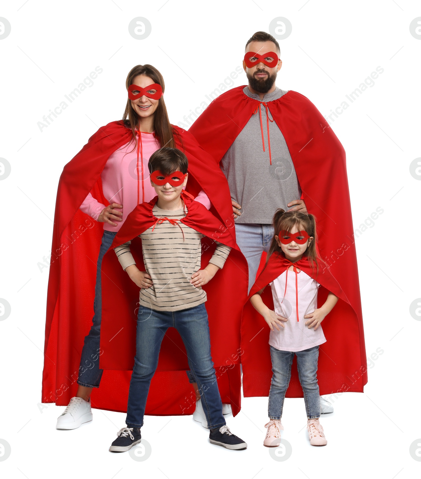 Photo of Parents and their children wearing superhero costumes on white background