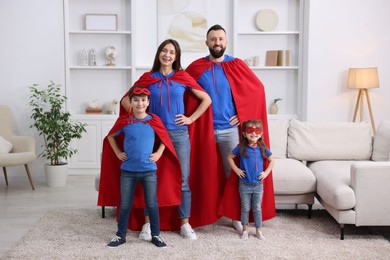 Photo of Parents and their children wearing superhero costumes at home