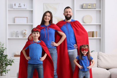 Photo of Parents and their children wearing superhero costumes at home