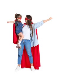 Photo of Mother and her cute little daughter wearing superhero costumes on white background