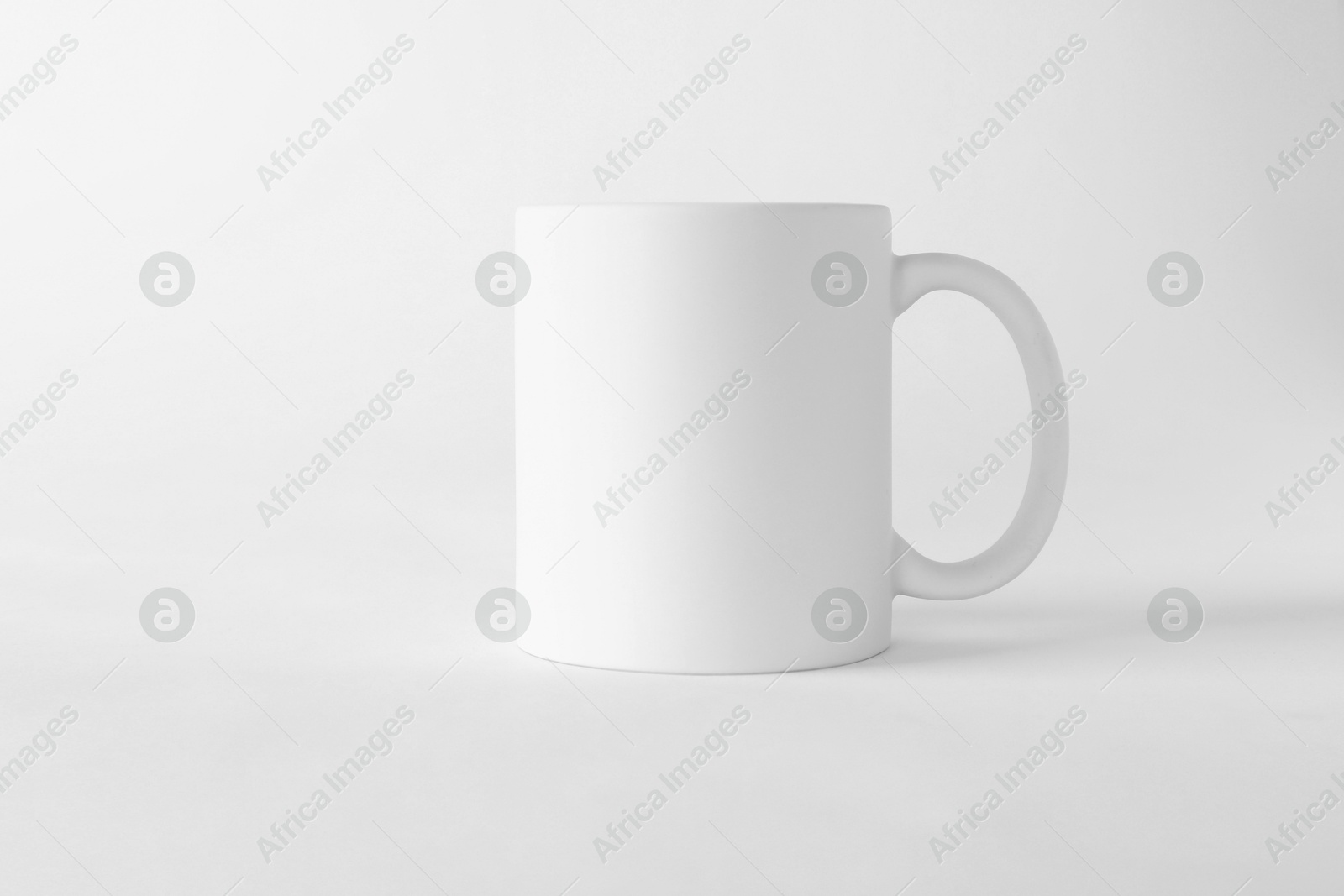 Photo of One blank mug on white background. Mockup for design