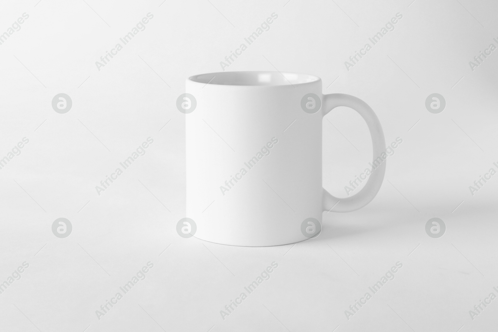 Photo of One blank mug on white background. Mockup for design