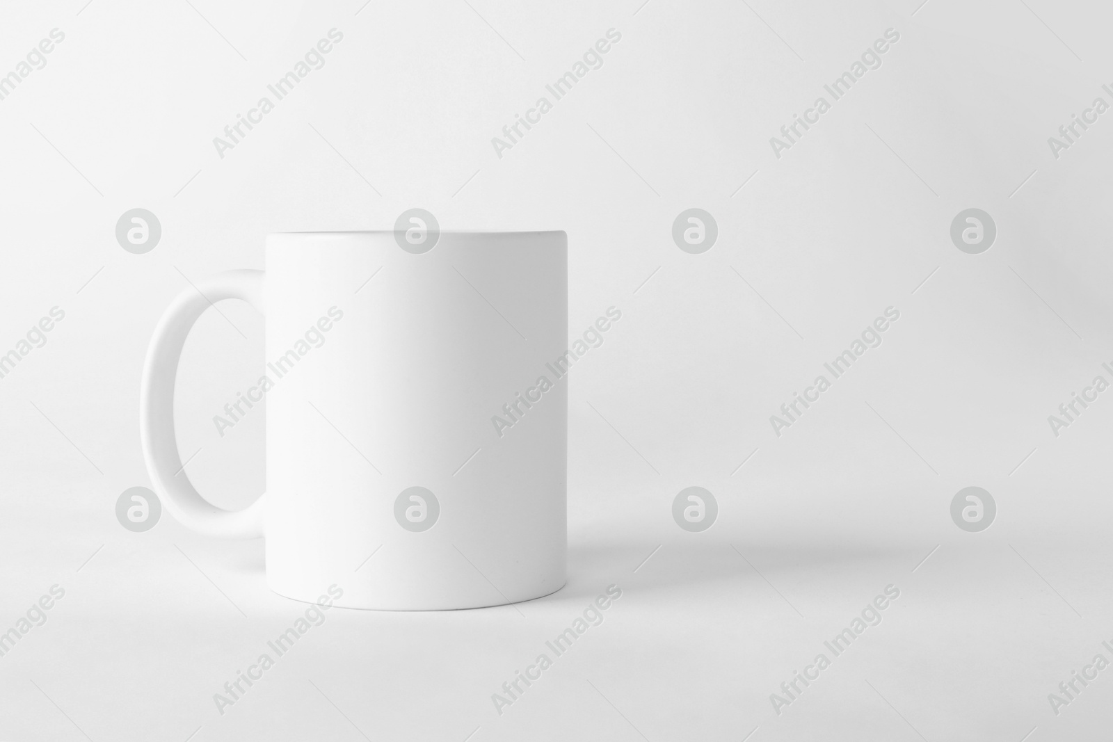 Photo of One blank mug on white background. Mockup for design