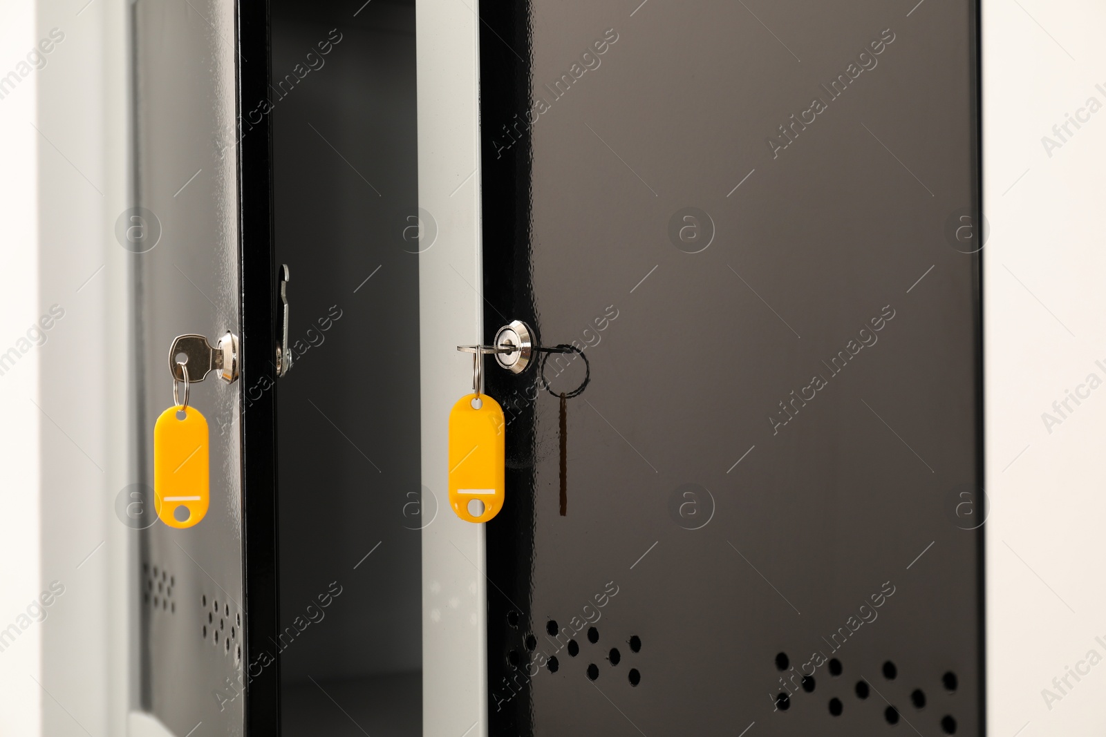 Photo of Modern lockers with bright keys indoors, closeup