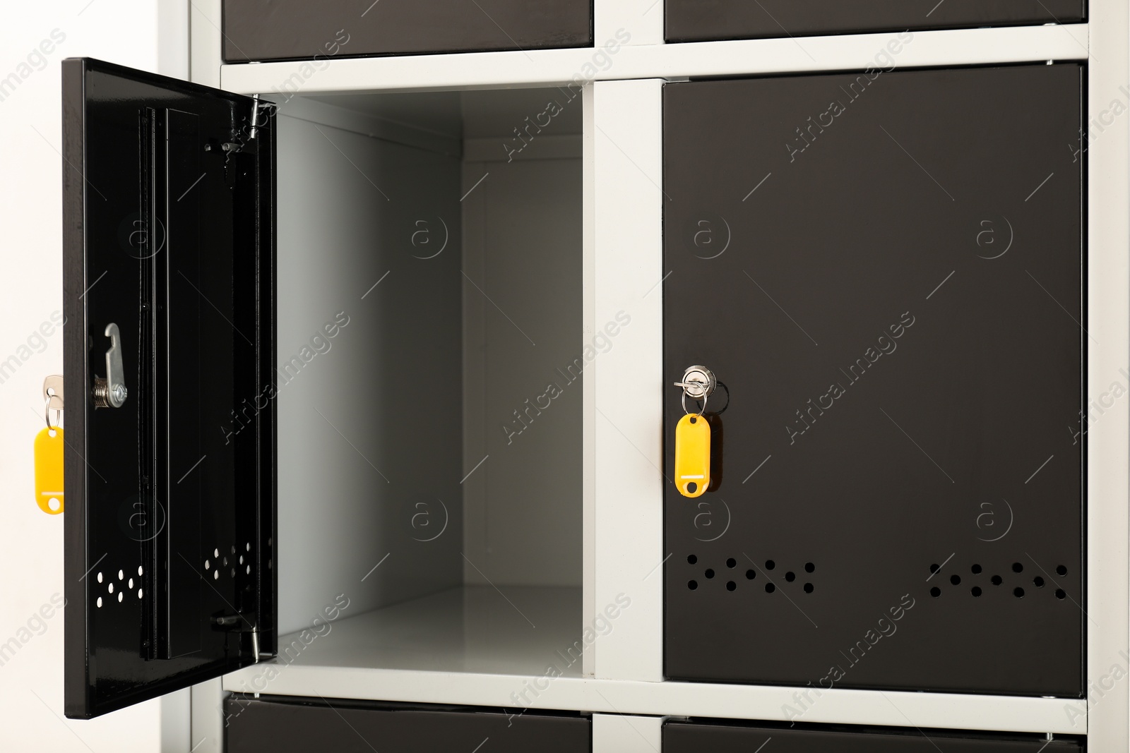 Photo of Modern lockers with bright keys indoors, closeup