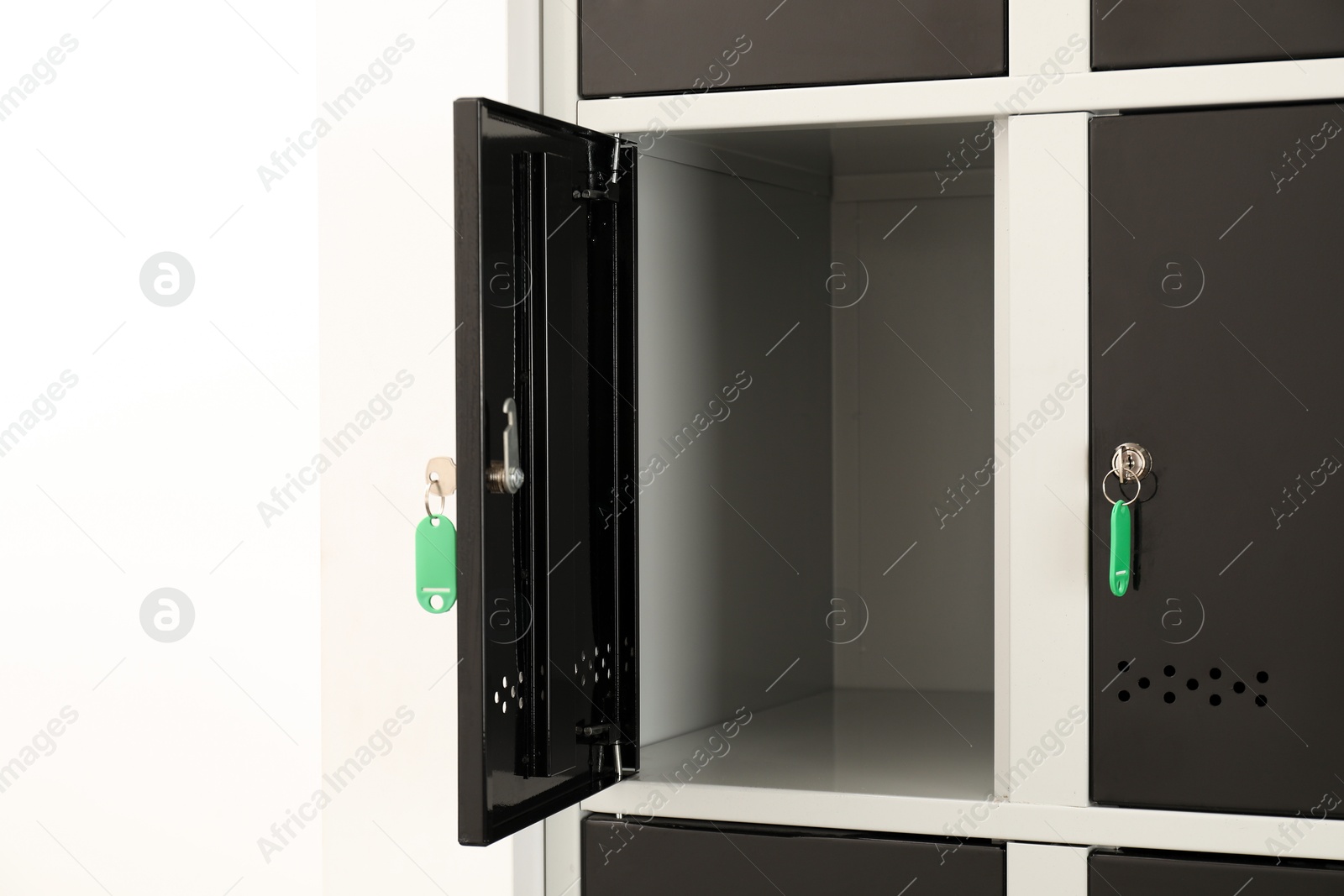 Photo of Modern lockers with keys on white background, closeup